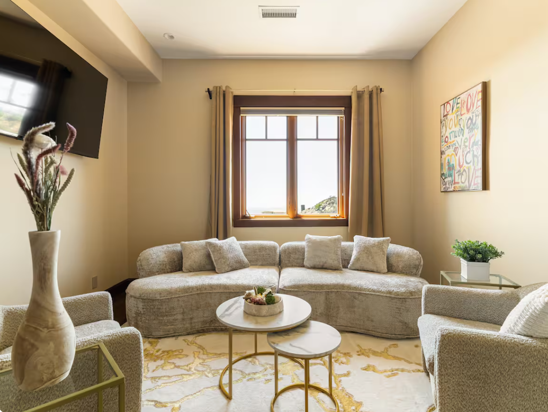 Private sitting lounge with boucle sofas and marble tables