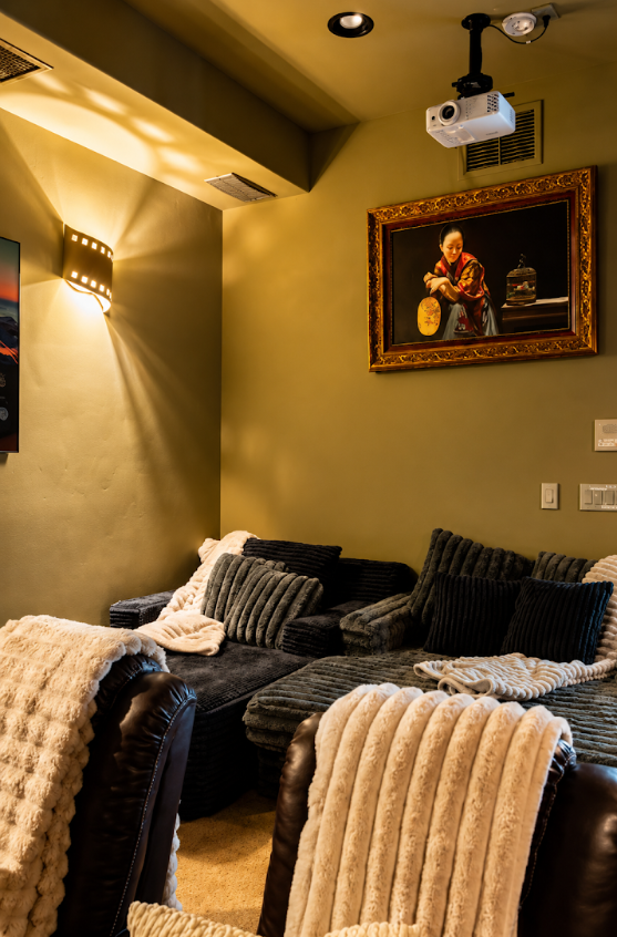 Plush chenille lounge seating beneath a gilded framed painting