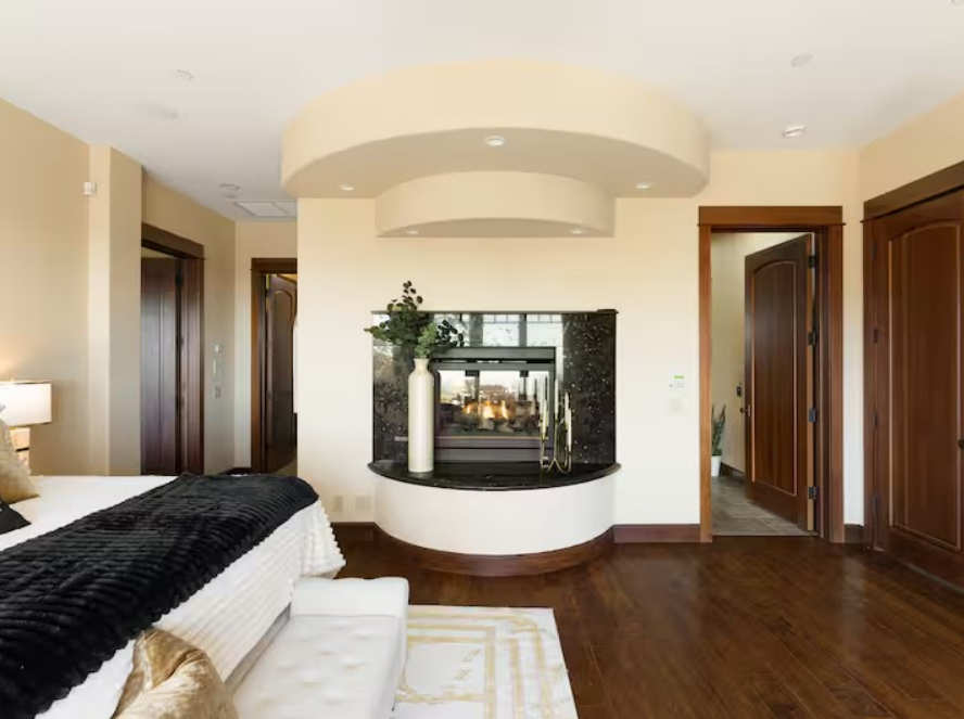 Suite fireplace with hardwood floors and interior sitting area