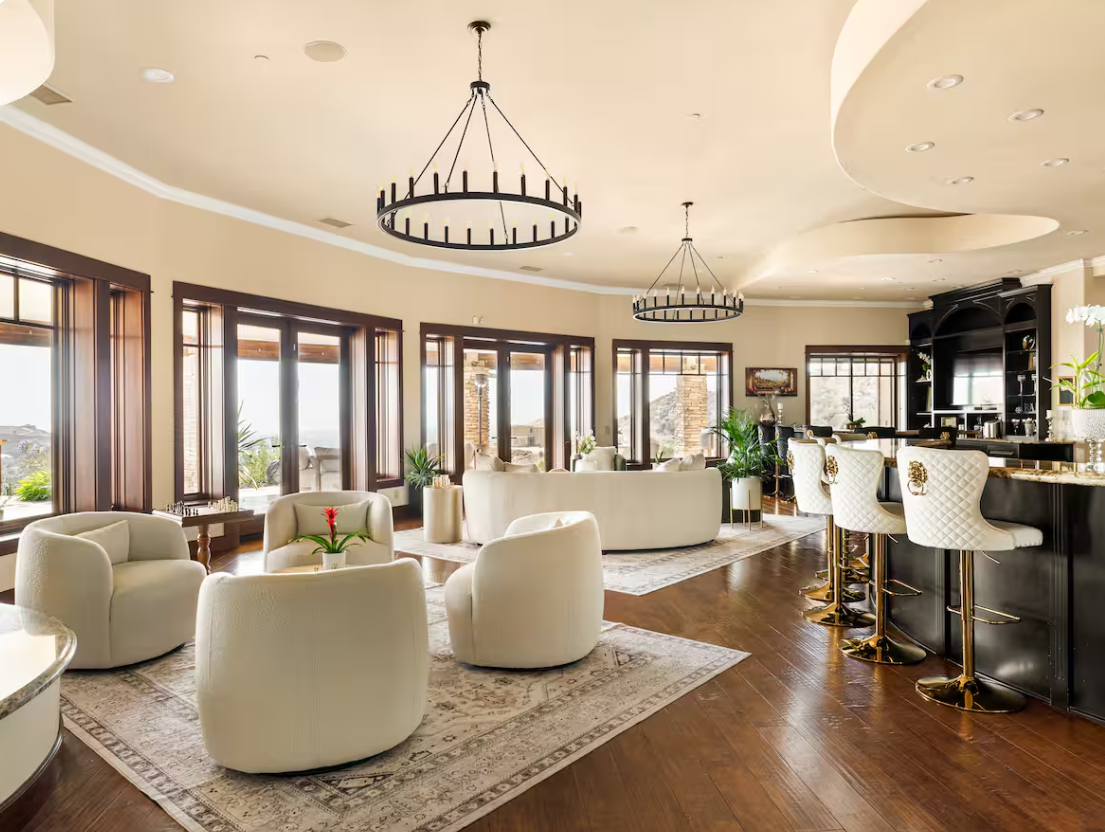 Lounge with twin chandeliers and window wall