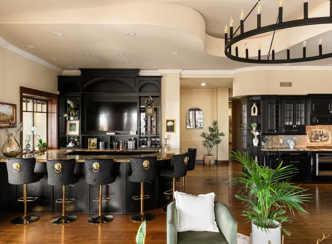 Black-and-gold private bar with lion-head barstools